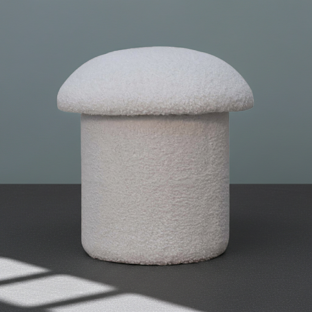 A mushroom-shaped pouf ottoman with a textured, fuzzy off-white bouclé fabric, set against a dark gray floor and a muted slate-gray background.