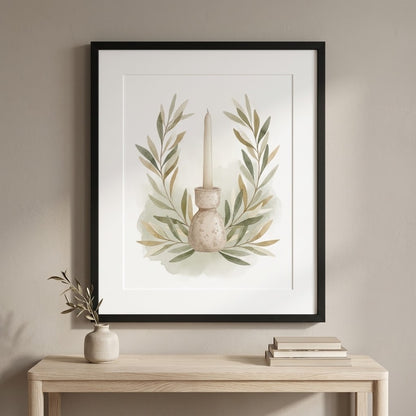 Framed botanical wall art hanging above a light wood console table, showing a candle in a vase surrounded by soft green and beige leaves on a white background.